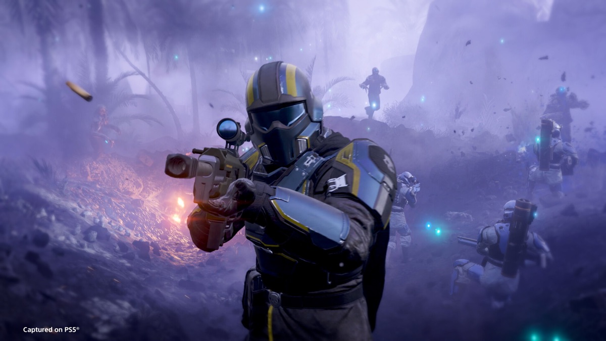 A Helldiver fires during a chaotic alien battle.