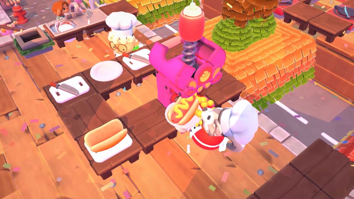 Four chefs work at separate stations in a busy kitchen.