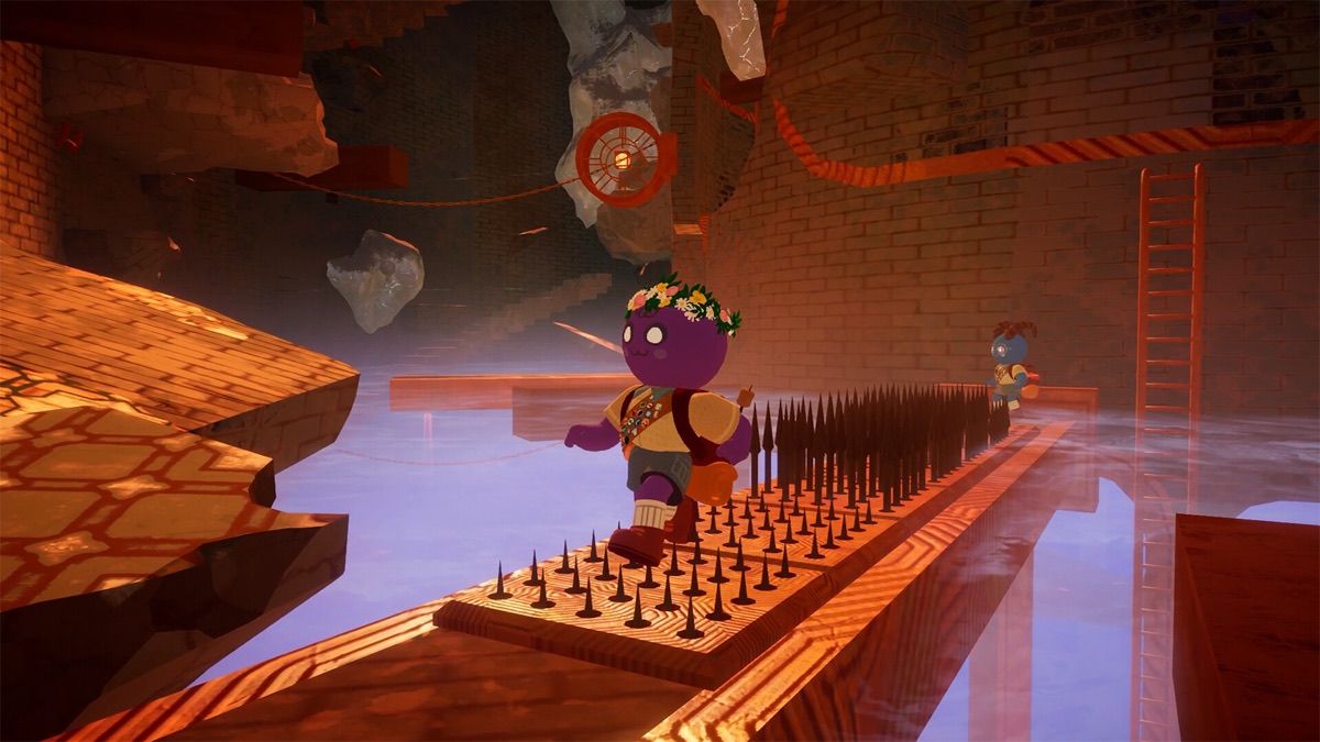 A climber navigates a cavern above a bed of spikes.