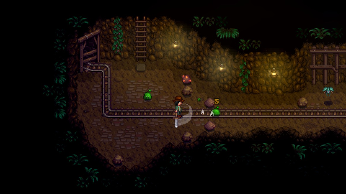 A farmer explores a dark mine with a torch.